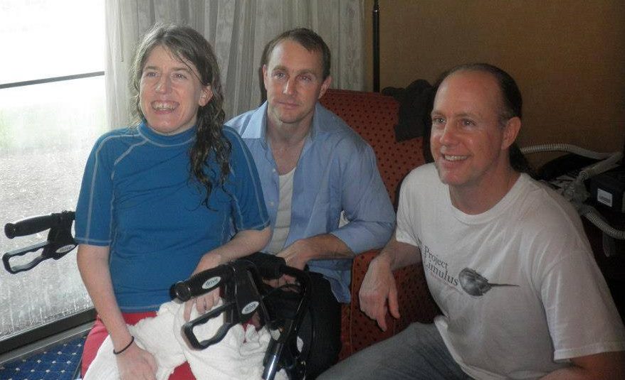 1 white woman and 2 white men, all smiling